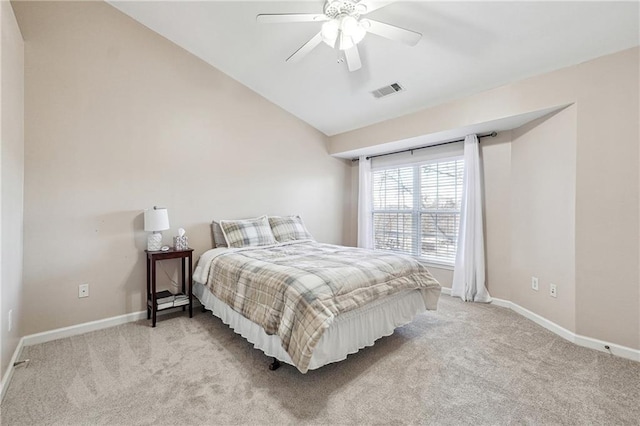 carpeted bedroom with visible vents, baseboards, vaulted ceiling, and ceiling fan