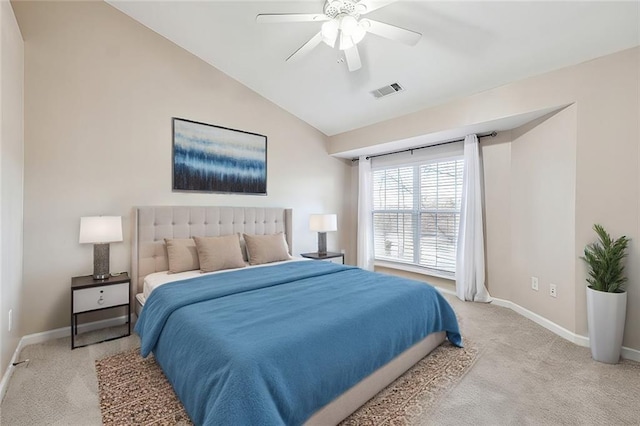 bedroom featuring vaulted ceiling, a ceiling fan, baseboards, light colored carpet, and visible vents