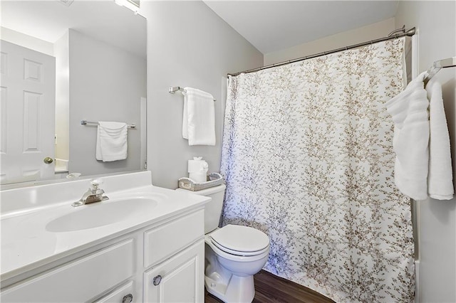 full bath with a shower with shower curtain, wood finished floors, toilet, and vanity