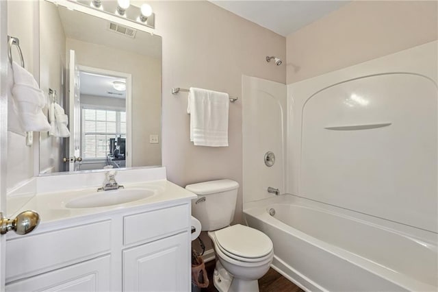 bathroom featuring shower / bath combination, visible vents, toilet, and vanity
