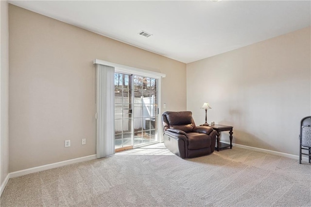 sitting room with baseboards, visible vents, and carpet