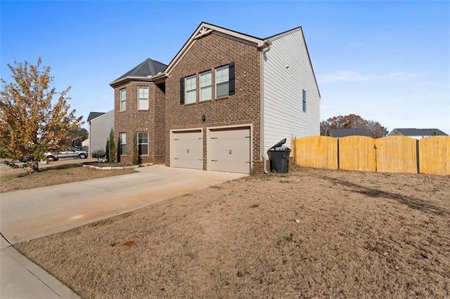165 Twin Lakes Dr, Covington, GA 30016 - view of side of property with brick siding, an attached garage, fence, and driveway