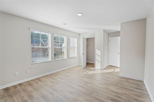 165 Twin Lakes Dr, Covington, GA 30016 - unfurnished bedroom featuring visible vents, light wood-style flooring, and baseboards