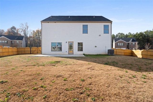 165 Twin Lakes Dr, Covington, GA 30016 - back of house with central air condition unit, a patio area, a fenced backyard, and a lawn