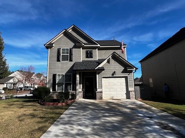 view of front of house featuring a front lawn and a garage