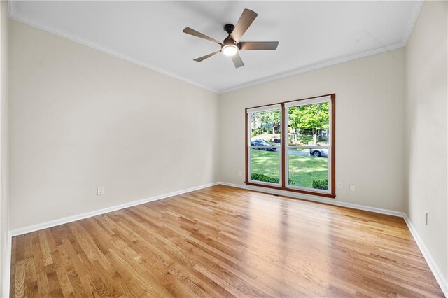 bathroom with crown molding, vanity, baseboards, toilet, and a shower with door
