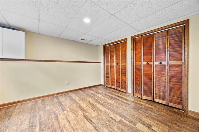 interior space featuring baseboards, recessed lighting, wood finished floors, and visible vents