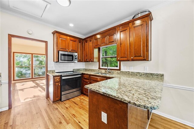 unfurnished living room with light wood-style flooring, ceiling fan with notable chandelier, baseboards, beamed ceiling, and visible vents