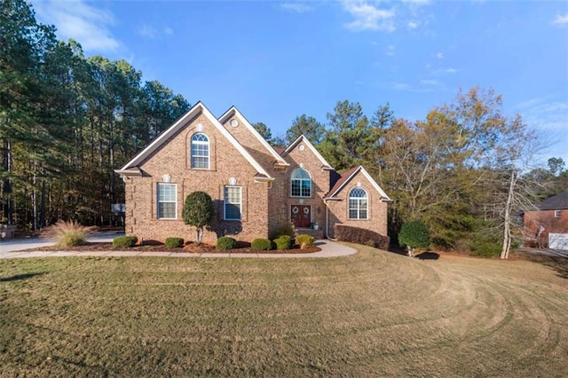 traditional home featuring brick siding and a front lawn