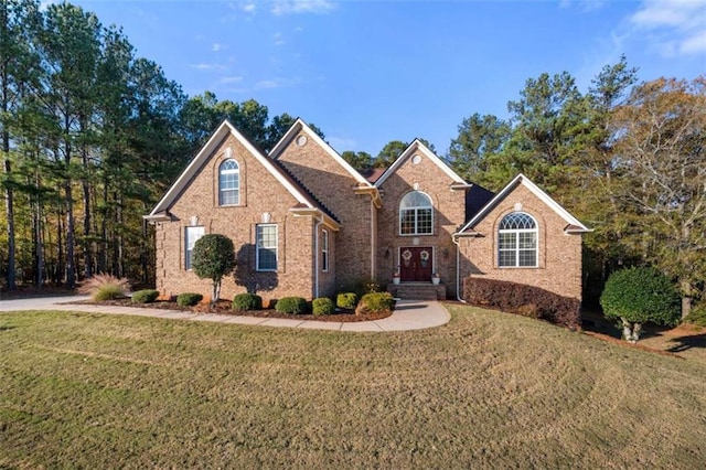 view of front of property featuring brick siding and a front lawn