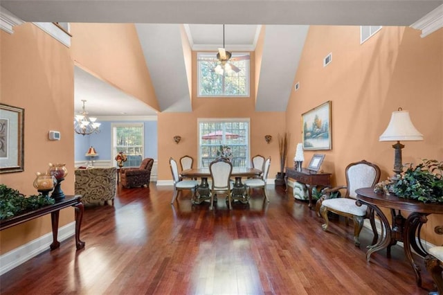 dining area featuring wood finished floors, crown molding, and plenty of natural light