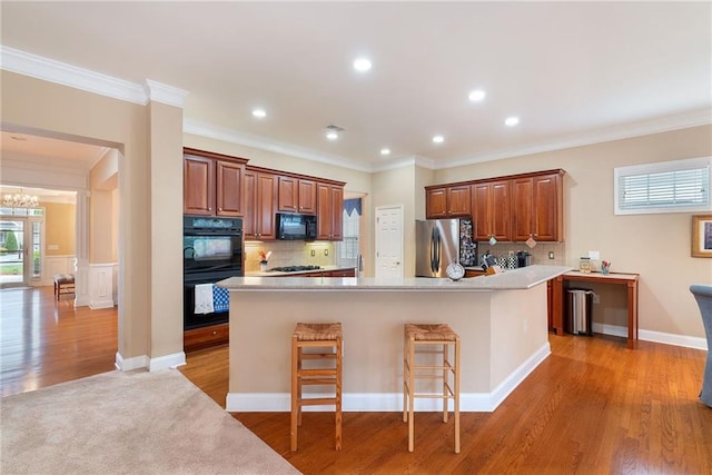6355 Marlow Dr, Cumming, GA 30041 - kitchen with crown molding, light countertops, black appliances, and tasteful backsplash