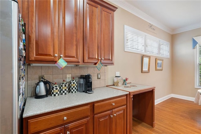 6355 Marlow Dr, Cumming, GA 30041 - kitchen featuring light wood-style flooring, freestanding refrigerator, decorative backsplash, light countertops, and ornamental molding