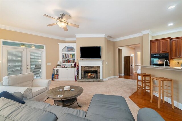 6355 Marlow Dr, Cumming, GA 30041 - living room with light wood finished floors, a fireplace, ceiling fan, and crown molding