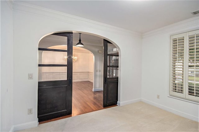 carpeted empty room with crown molding