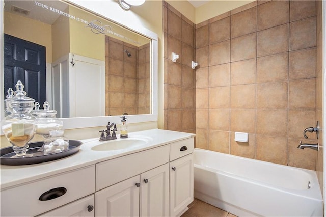 bathroom with vanity, tiled shower / bath combo, and tile patterned flooring