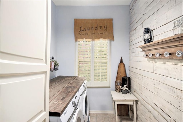 laundry area featuring light tile patterned flooring and washing machine and clothes dryer