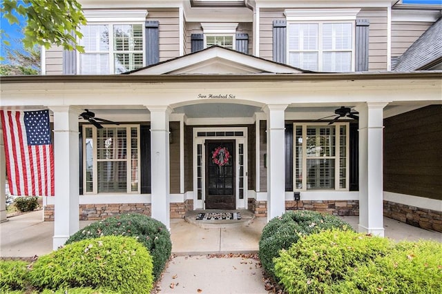 doorway to property featuring a porch and ceiling fan