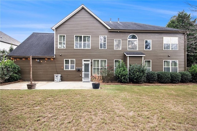 back of house featuring a patio and a lawn