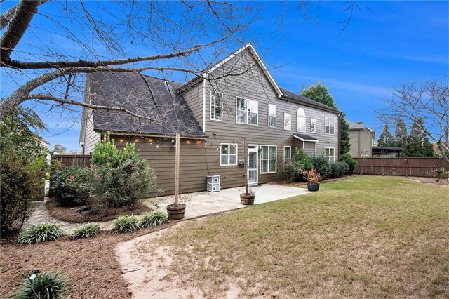 rear view of property featuring a patio and a lawn