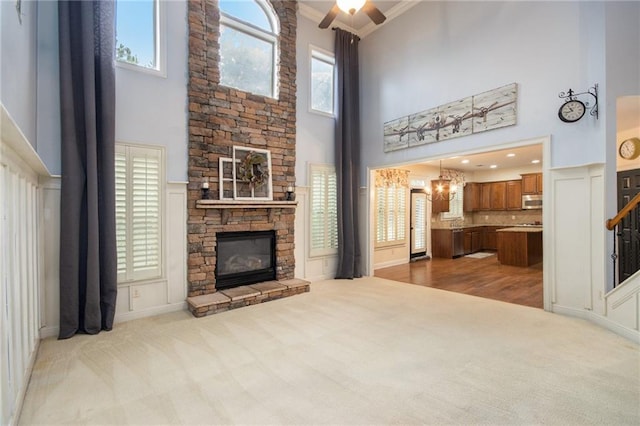 living room featuring light carpet, crown molding, and a towering ceiling