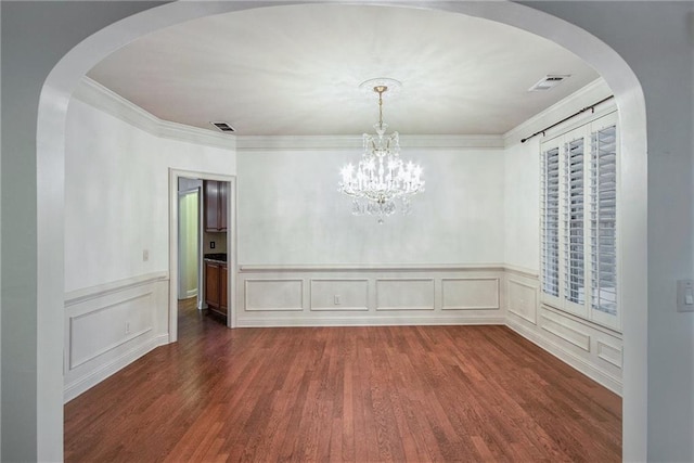 unfurnished dining area featuring a chandelier, crown molding, and dark hardwood / wood-style flooring