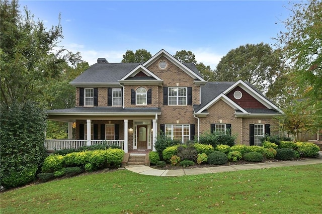 view of front of house featuring a front yard and covered porch