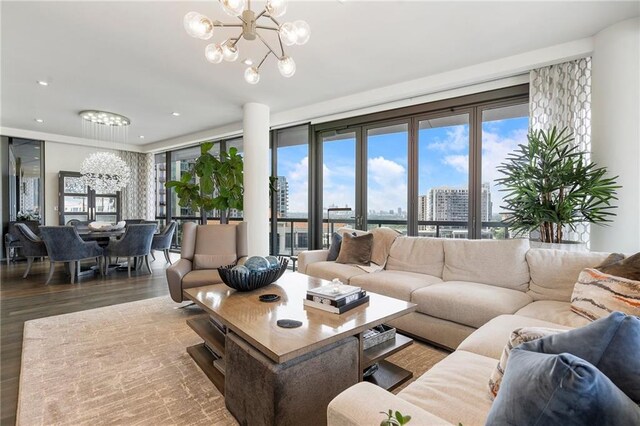 living room featuring recessed lighting, a view of city, a notable chandelier, and wood finished floors