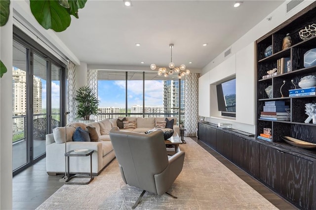 living area with visible vents, a healthy amount of sunlight, and wood finished floors