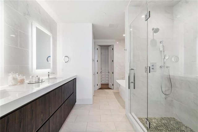 bathroom with tile patterned flooring, a shower stall, double vanity, a bathing tub, and a sink