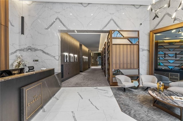 hallway with stone wall and marble finish floor