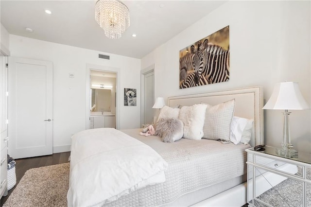 bedroom with recessed lighting, visible vents, connected bathroom, wood finished floors, and a chandelier