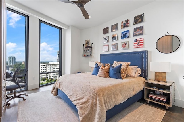 bedroom featuring access to outside, expansive windows, ceiling fan, and wood finished floors