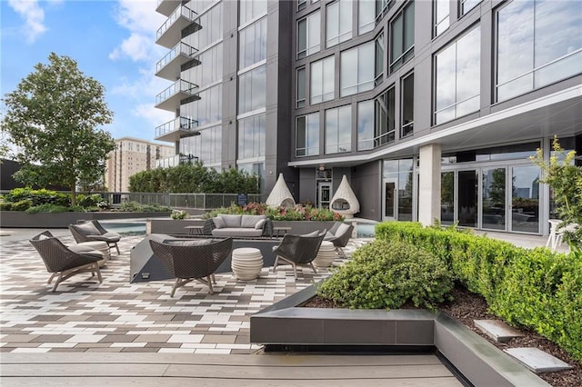 surrounding community featuring a patio area and outdoor lounge area