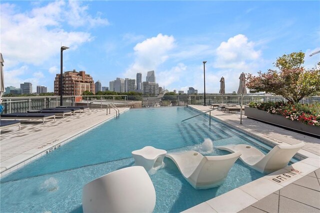 pool with a city view and a patio