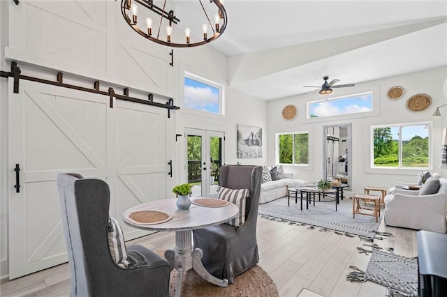 4791 Talona Rd, Talking Rock, GA 30175 - dining room featuring a barn door, light wood-type flooring, a high ceiling, ceiling fan, and a chandelier