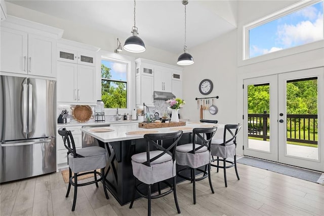 4791 Talona Rd, Talking Rock, GA 30175 - kitchen with stainless steel appliances, under cabinet range hood, light countertops, decorative backsplash, and a center island