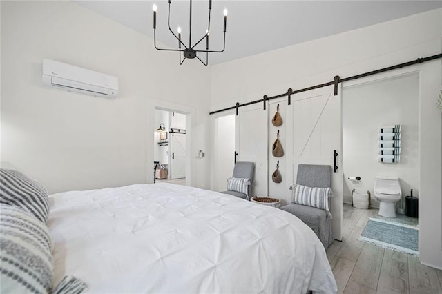 4791 Talona Rd, Talking Rock, GA 30175 - bedroom with a barn door, a wall mounted AC, wood finished floors, and a chandelier