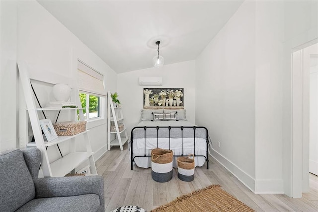 4791 Talona Rd, Talking Rock, GA 30175 - bedroom featuring light wood-style floors, a wall mounted air conditioner, vaulted ceiling, and baseboards