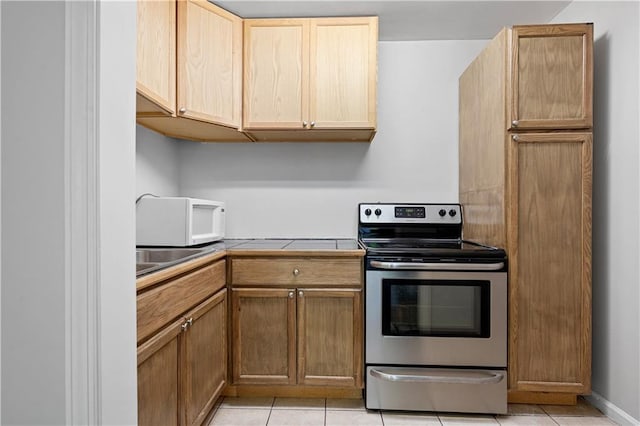 5971 Dogwood Dr SE, Acworth, GA 30102 - kitchen featuring electric stove, white microwave, light tile patterned flooring, tile countertops, and a sink