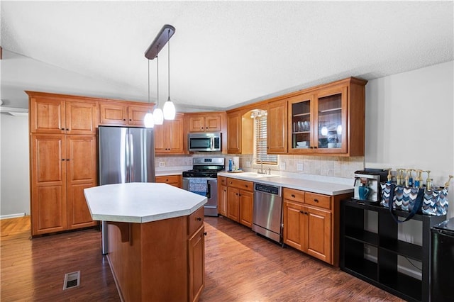 5971 Dogwood Dr SE, Acworth, GA 30102 - kitchen with appliances with stainless steel finishes, light countertops, tasteful backsplash, a kitchen island, and vaulted ceiling