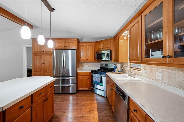 5971 Dogwood Dr SE, Acworth, GA 30102 - kitchen with stainless steel appliances, a sink, light countertops, dark wood finished floors, and brown cabinetry