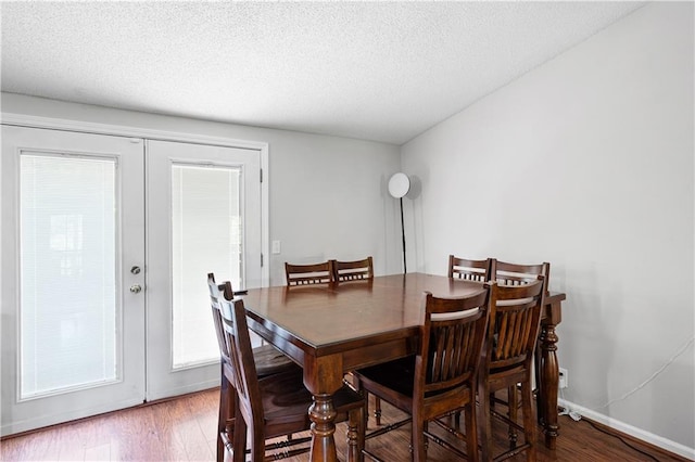 5971 Dogwood Dr SE, Acworth, GA 30102 - dining area featuring french doors, wood finished floors, a textured ceiling, and baseboards