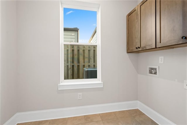 laundry room featuring cabinets, washer hookup, and light tile patterned floors