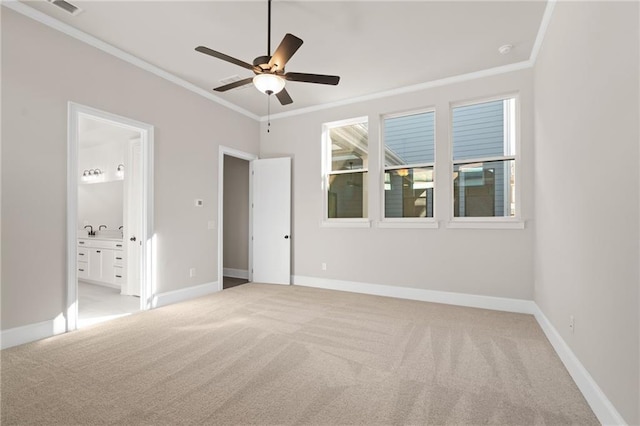 unfurnished bedroom featuring light colored carpet, ornamental molding, ceiling fan, and ensuite bathroom