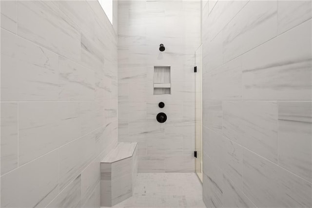 bathroom with a tile shower