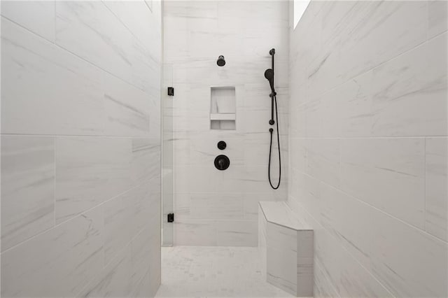 bathroom featuring a tile shower