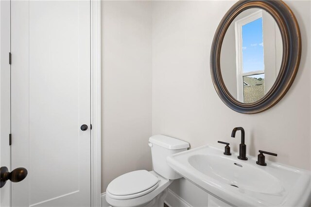 bathroom with toilet and sink