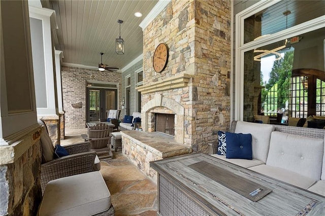 view of patio / terrace with french doors and an outdoor stone fireplace