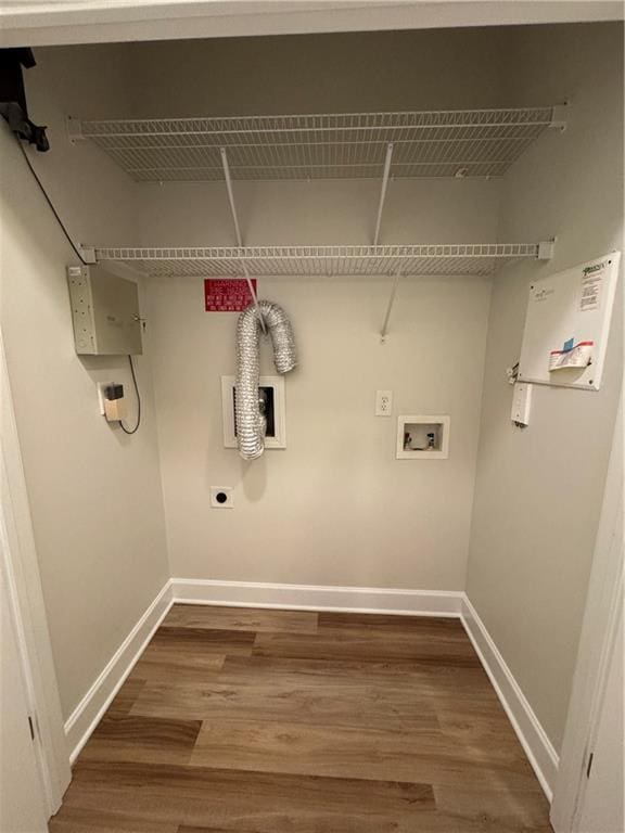 clothes washing area featuring washer hookup, baseboards, electric dryer hookup, and wood finished floors